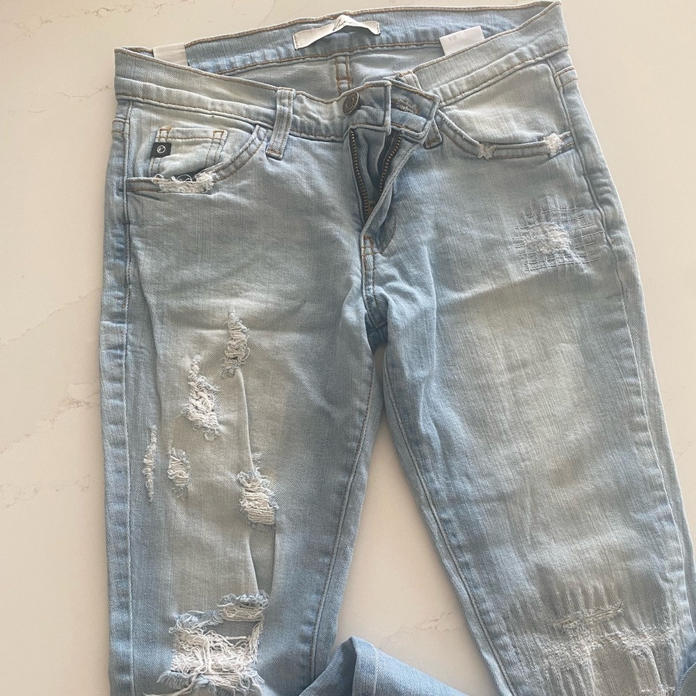 Skinny jeans with rips in knees and thigh area